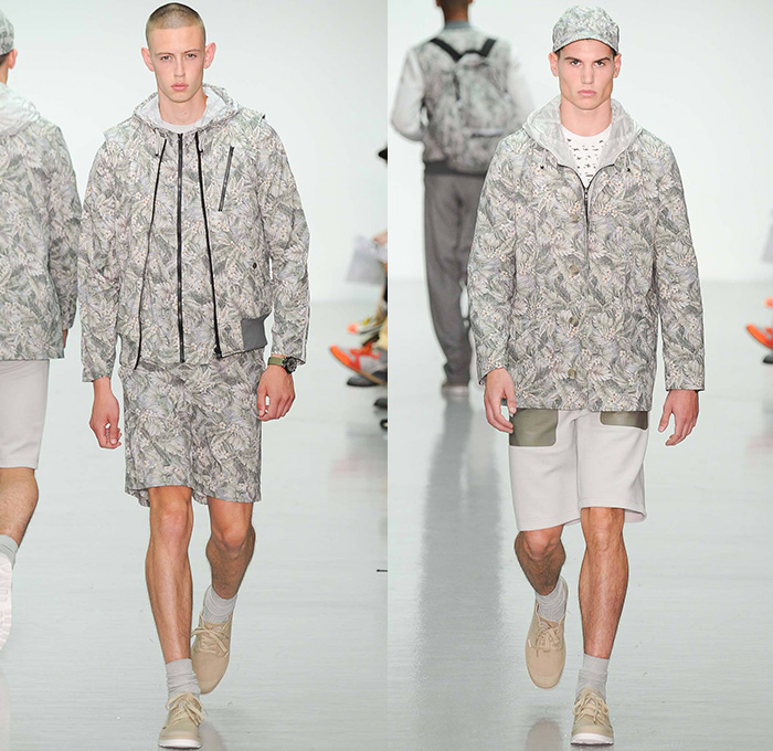 Christopher Raeburn 2015 Spring Summer Mens Runway Looks - London Collections British Fashion Council UK United Kingdom - Meridian Desert Boneyards Aviator Aircraft Military Airplanes Helicopters Missiles Motif Graphic Print Utility Perforated Mesh Parachute Bomber Jacket Outerwear Hoodie Backpack Anorak Parka Knee Panel Jogging Sweatpants Playing Cards Geometric Sweater Jumper Flowers Florals Fauna Leaves Foliage Nylon Lightweight Translucent Blazer Shorts