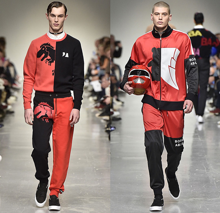 Bobby Abley 2017-2018 Fall Autumn Winter Mens Runway Catwalk Looks - London Collections Fashion Week Mens British Fashion Council UK United Kingdom - Power Rangers Dinosaurs Teddy Bear Pop Art Knit Sweater Jumper Furry Shaggy Shearling Mohair Shorts Over Leggings Straps Arm Warmers Sweatpants Jogger Colorblock Tracksuit Outerwear Coat Crop Top Midriff Leg Panels Poncho Cloak Trucker Jacket Harness Trainers Shoes Choker Helmet Tote Bag Denim Jeans