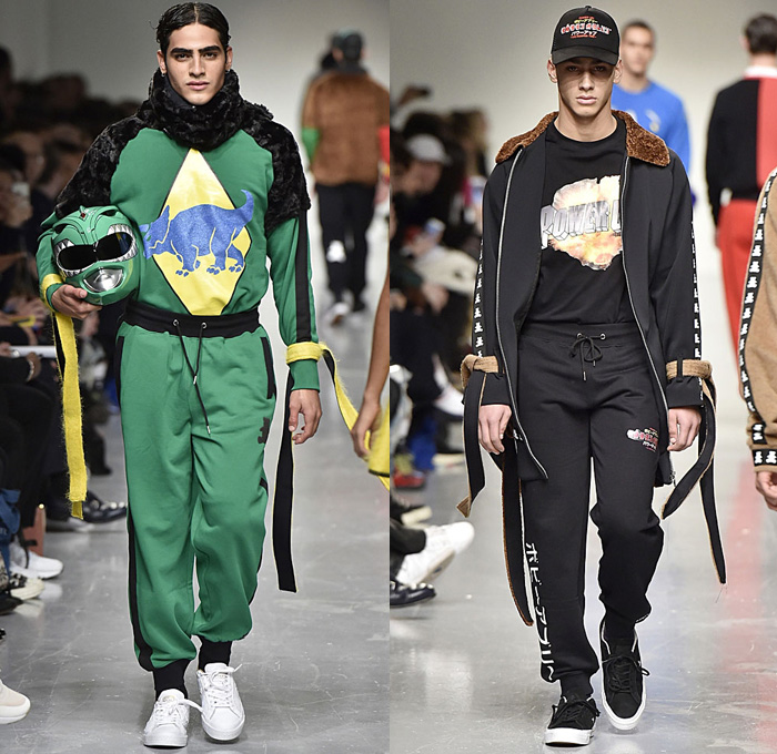 Bobby Abley 2017-2018 Fall Autumn Winter Mens Runway Catwalk Looks - London Collections Fashion Week Mens British Fashion Council UK United Kingdom - Power Rangers Dinosaurs Teddy Bear Pop Art Knit Sweater Jumper Furry Shaggy Shearling Mohair Shorts Over Leggings Straps Arm Warmers Sweatpants Jogger Colorblock Tracksuit Outerwear Coat Crop Top Midriff Leg Panels Poncho Cloak Trucker Jacket Harness Trainers Shoes Choker Helmet Tote Bag Denim Jeans