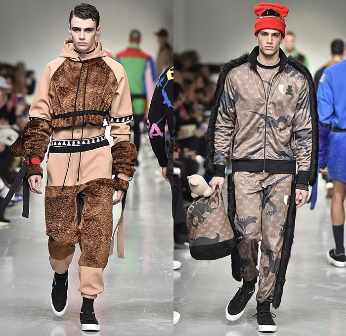 Bobby Abley 2017-2018 Fall Autumn Winter Mens Runway Catwalk Looks - London Collections Fashion Week Mens British Fashion Council UK United Kingdom - Power Rangers Dinosaurs Teddy Bear Pop Art Knit Sweater Jumper Furry Shaggy Shearling Mohair Shorts Over Leggings Straps Arm Warmers Sweatpants Jogger Colorblock Tracksuit Outerwear Coat Crop Top Midriff Leg Panels Poncho Cloak Trucker Jacket Harness Trainers Shoes Choker Helmet Tote Bag Denim Jeans