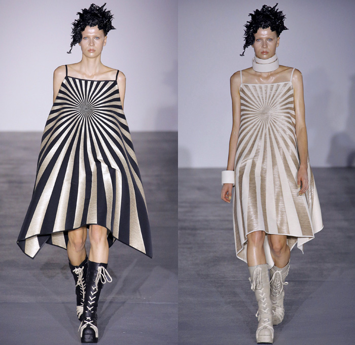 Gareth Pugh 2017 Spring Summer Womens Runway Catwalk Looks - London Fashion Week Collections British Fashion Council UK United Kingdom - Sun Goddess Empress Sundress Caftan Sunburst Stripes Embroidery Embellishments Bedazzled Golden Metallic Geometric Triangles Prism Headwear Headdress Coat Punk Gothic Structured Shawl High Slit Hanging Sleeve Drapery Sheer Chiffon Pantsuit Balloon Maxi Dress Silk Balloon Maxi Dress One Shoulder Noodle Strap Bangles Bracelet Necklace Choker Wide Leg Kimono Obi Sash Boots