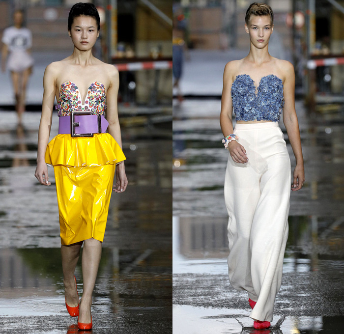 Marina Hoermanseder 2018 Spring Summer Womens Runway Catwalk Looks - Berlin Fashion Week Germany Deutschland Frühjahr Sommer 2018 - Matryoshka Russian Nesting Babushka Doll Mega Buckle Wide Belt Sculptural Straps Wrap Around Bustier Corset Strapless PVC Vinyl Pleather Bedazzled Metallic Studs Denim Jeans Sheer Chiffon Organza Tulle Turtleneck Sweater Jumper Shirt Crop Top Midriff Tiered Ruffles Flounce Flowers Floral Botanical Embroidery Belt Skirt Miniskirt Peplum Wide Leg Trousers Palazzo Pants Leotard Thigh High Boots Headscarf Tote Handbag