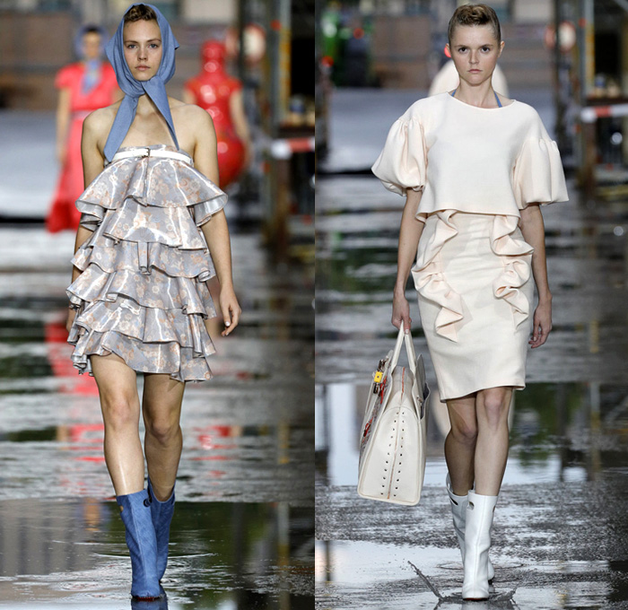 Marina Hoermanseder 2018 Spring Summer Womens Runway Catwalk Looks - Berlin Fashion Week Germany Deutschland Frühjahr Sommer 2018 - Matryoshka Russian Nesting Babushka Doll Mega Buckle Wide Belt Sculptural Straps Wrap Around Bustier Corset Strapless PVC Vinyl Pleather Bedazzled Metallic Studs Denim Jeans Sheer Chiffon Organza Tulle Turtleneck Sweater Jumper Shirt Crop Top Midriff Tiered Ruffles Flounce Flowers Floral Botanical Embroidery Belt Skirt Miniskirt Peplum Wide Leg Trousers Palazzo Pants Leotard Thigh High Boots Headscarf Tote Handbag