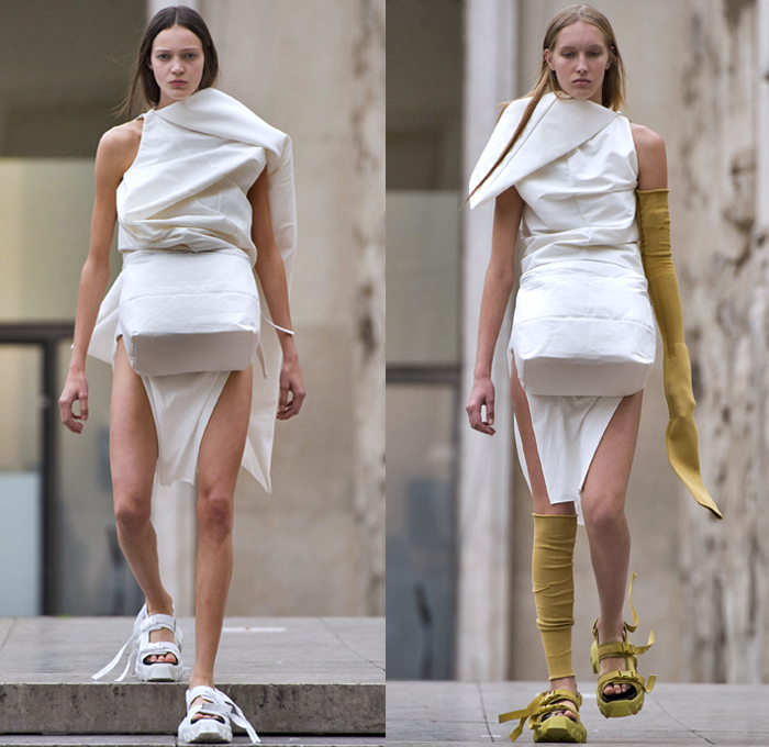 Rick Owens 2018 Spring Summer Womens Runway Catwalk Looks - Mode à Paris Fashion Week Mode Féminin France - Dirt Dimensional Structural Organic Shape Sculptural Futuristic Pillow Wrap Cocoon Stuffed Outerwear Coat Blazerdress Hanging Sleeve Cape Shawl Blanket Holes Wrap Drapery Leather Peel Away Angular Pointed Tie Up Metallic Sheen Strapless Dress Gown Blouse Skirt Pleats Sleeveless One Shoulder Duffeldress Shorts Sneakers Sandals Warmers Asymmetrical Fanny Pack Waist Pouch Belt Bag