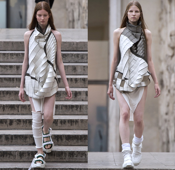 Rick Owens 2018 Spring Summer Womens Runway Catwalk Looks - Mode à Paris Fashion Week Mode Féminin France - Dirt Dimensional Structural Organic Shape Sculptural Futuristic Pillow Wrap Cocoon Stuffed Outerwear Coat Blazerdress Hanging Sleeve Cape Shawl Blanket Holes Wrap Drapery Leather Peel Away Angular Pointed Tie Up Metallic Sheen Strapless Dress Gown Blouse Skirt Pleats Sleeveless One Shoulder Duffeldress Shorts Sneakers Sandals Warmers Asymmetrical Fanny Pack Waist Pouch Belt Bag