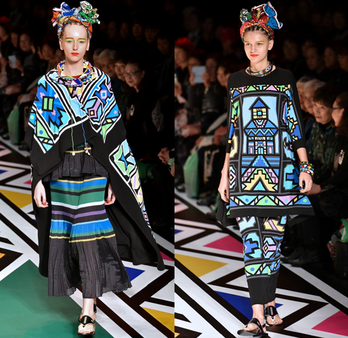 Tokuko 1er Vol by Tokuko Maeda 2018 Spring Summer Womens Runway Catwalk Looks - Amazon Fashion Week Tokyo Japan AmazonFWT - Cloak Blanket Shawl Turtleneck Embroidery Ornamental Print Decorative Art Tribal Ethnic Folk Geometric Church Building Ocean Illustration Faces Mesh Fishnet Accordion Pleats Flowers Floral Leaves Foliage Plants Sheer Tulle Perforated Lasercut Lace Animals Jungle Safari LED Lights Lantern Dress Tiered Wide Leg Headwear Turban Earrings Sandals Bangles Necklace Beads