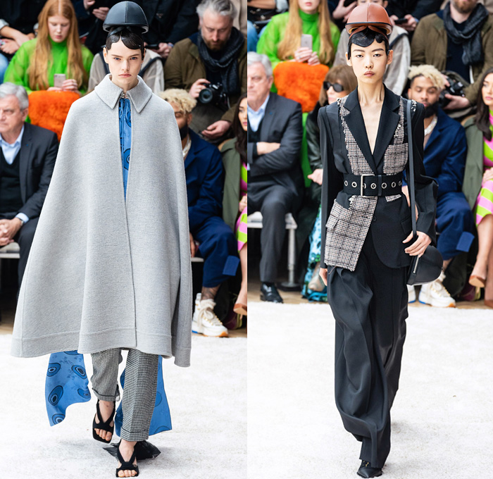 JW Anderson 2019-2020 Fall Autumn Winter Womens Runway Catwalk Looks - London Fashion Week Collections UK - Action Figure Doll Hair Oversized Wide Neckline Slouchy Sleeves Trench Coat Check Plaid Stripes Dots Sheer Tulle Cape Poncho Tie Up Waist Patchwork Blazer Pantsuit Lace Needlework Embroidery Houndstooth Tweed Paisley Knit Turtleneck Sweaterdress Hanging Sleeve Wide Leg Pants Belt Ruffles Bedazzled Silk Satin Dress Draped Fringes Gown Chain Equestrian Hat Bag Boots