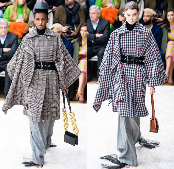 JW Anderson 2019-2020 Fall Autumn Winter Womens Runway Catwalk Looks - London Fashion Week Collections UK - Action Figure Doll Hair Oversized Wide Neckline Slouchy Sleeves Trench Coat Check Plaid Stripes Dots Sheer Tulle Cape Poncho Tie Up Waist Patchwork Blazer Pantsuit Lace Needlework Embroidery Houndstooth Tweed Paisley Knit Turtleneck Sweaterdress Hanging Sleeve Wide Leg Pants Belt Ruffles Bedazzled Silk Satin Dress Draped Fringes Gown Chain Equestrian Hat Bag Boots