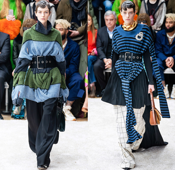 JW Anderson 2019-2020 Fall Autumn Winter Womens Runway Catwalk Looks - London Fashion Week Collections UK - Action Figure Doll Hair Oversized Wide Neckline Slouchy Sleeves Trench Coat Check Plaid Stripes Dots Sheer Tulle Cape Poncho Tie Up Waist Patchwork Blazer Pantsuit Lace Needlework Embroidery Houndstooth Tweed Paisley Knit Turtleneck Sweaterdress Hanging Sleeve Wide Leg Pants Belt Ruffles Bedazzled Silk Satin Dress Draped Fringes Gown Chain Equestrian Hat Bag Boots