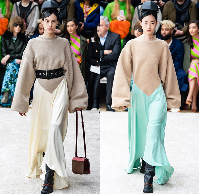 JW Anderson 2019-2020 Fall Autumn Winter Womens Runway Catwalk Looks - London Fashion Week Collections UK - Action Figure Doll Hair Oversized Wide Neckline Slouchy Sleeves Trench Coat Check Plaid Stripes Dots Sheer Tulle Cape Poncho Tie Up Waist Patchwork Blazer Pantsuit Lace Needlework Embroidery Houndstooth Tweed Paisley Knit Turtleneck Sweaterdress Hanging Sleeve Wide Leg Pants Belt Ruffles Bedazzled Silk Satin Dress Draped Fringes Gown Chain Equestrian Hat Bag Boots