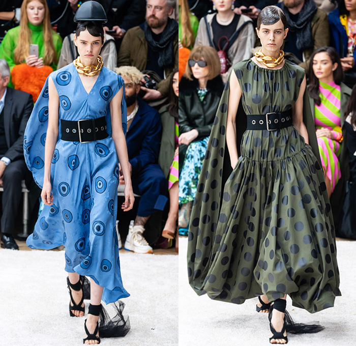 JW Anderson 2019-2020 Fall Autumn Winter Womens Runway Catwalk Looks - London Fashion Week Collections UK - Action Figure Doll Hair Oversized Wide Neckline Slouchy Sleeves Trench Coat Check Plaid Stripes Dots Sheer Tulle Cape Poncho Tie Up Waist Patchwork Blazer Pantsuit Lace Needlework Embroidery Houndstooth Tweed Paisley Knit Turtleneck Sweaterdress Hanging Sleeve Wide Leg Pants Belt Ruffles Bedazzled Silk Satin Dress Draped Fringes Gown Chain Equestrian Hat Bag Boots