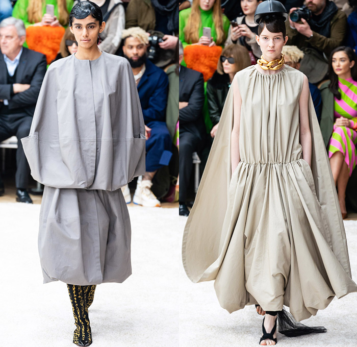 JW Anderson 2019-2020 Fall Autumn Winter Womens Runway Catwalk Looks - London Fashion Week Collections UK - Action Figure Doll Hair Oversized Wide Neckline Slouchy Sleeves Trench Coat Check Plaid Stripes Dots Sheer Tulle Cape Poncho Tie Up Waist Patchwork Blazer Pantsuit Lace Needlework Embroidery Houndstooth Tweed Paisley Knit Turtleneck Sweaterdress Hanging Sleeve Wide Leg Pants Belt Ruffles Bedazzled Silk Satin Dress Draped Fringes Gown Chain Equestrian Hat Bag Boots