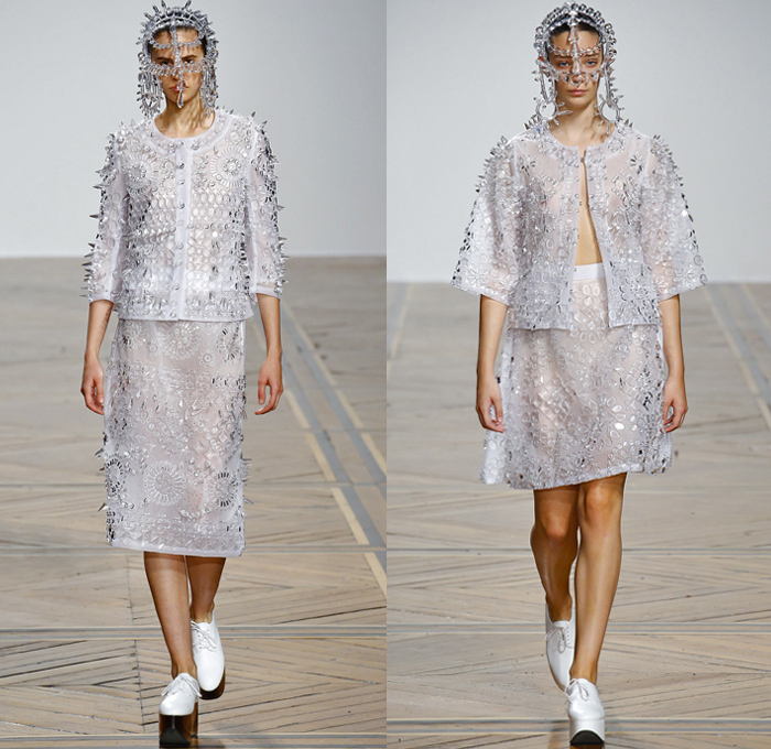 ANREALAGE 2019 Spring Summer Womens Runway Catwalk Looks Collection Kunihiko Morinaga - Mode à Paris Fashion Week France - Clear Futuristic Technical Fabrics UV Ultraviolet Light Photochromic Crystals Glass Plastic Bedazzled Embroidery Adorned Sequins Paillettes Spikes Geometric Stars Floral Flowers Ornaments Buttons Prismatic Gemstones Jewels Sheer Headwear Jeans Bomber Jacket Military Hybrid Deconstructed Trench Coat Dress Tiered Ruffles Turtleneck Knit Crochet Bangles Sneakers