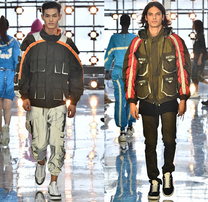 Byblos 2019 Spring Summer Mens Runway Catwalk Looks Collection - Milano Moda Donna Collezione Milan Fashion Week Italy - Burning Man Festival Recycling Destroyed Denim Jeans Metallic Silver Foil Bomber Jacket Feathers Sunglasses Cargo Pockets Shorts Backpack Parachute Pants Nylon Onesie Jumpsuit Coveralls Paratrooper