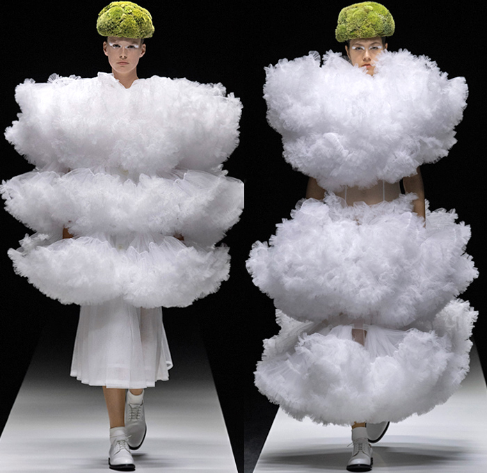 Noir Kei Ninomiya 2020 Spring Summer Womens Runway Catwalk Looks Collection - Mode à Paris Fashion Week France - Sculpture Cocoon Clouds Sheer Tulle Ruffles Tiered Furry Spikes Broccoli Grass Headwear Coral Mask Trompe L'oeil Lace Embroidery Needlework Flowers Floral Leaves Foliage Harness Straps Belts Pussycat Bow Ribbons Fringes Loops Mesh Shrub Perforated Racing Check Poufy Shoulders Pinafore Dress  Pins Needles Chandelier Gown Hoodie Trench Coat Motorcycle Biker Leather Jacket 