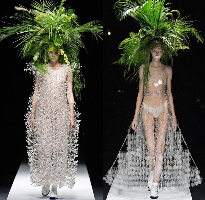 Noir Kei Ninomiya 2020 Spring Summer Womens Runway Catwalk Looks Collection - Mode à Paris Fashion Week France - Sculpture Cocoon Clouds Sheer Tulle Ruffles Tiered Furry Spikes Broccoli Grass Headwear Coral Mask Trompe L'oeil Lace Embroidery Needlework Flowers Floral Leaves Foliage Harness Straps Belts Pussycat Bow Ribbons Fringes Loops Mesh Shrub Perforated Racing Check Poufy Shoulders Pinafore Dress  Pins Needles Chandelier Gown Hoodie Trench Coat Motorcycle Biker Leather Jacket 