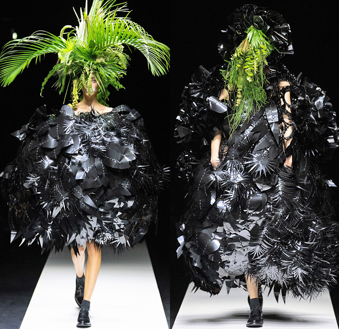 Noir Kei Ninomiya 2020 Spring Summer Womens Runway Catwalk Looks Collection - Mode à Paris Fashion Week France - Sculpture Cocoon Clouds Sheer Tulle Ruffles Tiered Furry Spikes Broccoli Grass Headwear Coral Mask Trompe L'oeil Lace Embroidery Needlework Flowers Floral Leaves Foliage Harness Straps Belts Pussycat Bow Ribbons Fringes Loops Mesh Shrub Perforated Racing Check Poufy Shoulders Pinafore Dress  Pins Needles Chandelier Gown Hoodie Trench Coat Motorcycle Biker Leather Jacket 