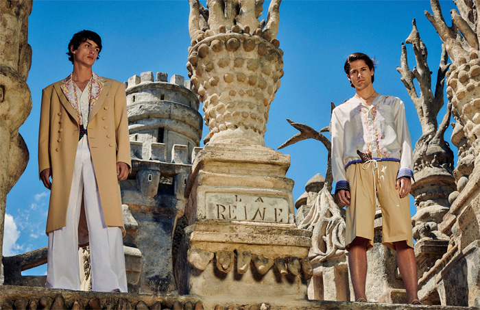 Lanvin 2021 Spring Summer Mens + 2021 Resort Womens Lookbook Presentation - Palais Idéal du Facteur Ferdinand Cheval Medieval Castle Ideal Palace Art Deco Illustration Prints Erté Turban Hat Silk Scarf Sunglasses Polka Dots Ruffles Wide Sleeves Blouse Dress Blazer Trench Coat Cape Poncho Gloves Skirt Shorts Wide Leg Palazzo Pants Stripes Cardigan Shirt Snakeskin Cheetah Handbag Loafers Sandals