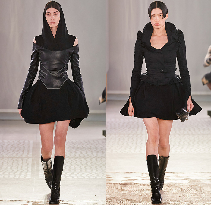 Trussardi 2022-2023 Fall Autumn Winter Womens Runway Looks - Milano Moda Donna Collezione Milan Fashion Week Italy - Strapless Open Shoulders Crop Top Midriff Quilted Puffer Jacket Hoodie Oversized Outerwear Coat Fur Shearling Velvet Zipper Corset Shapewear Crinoline Poodle Skirt High Slit Knit Denim Jeans Miniskirt Wide Leg Baggy Loose Pleats Utility Pockets Cargo Pants Thigh High Boots Handbag Purse