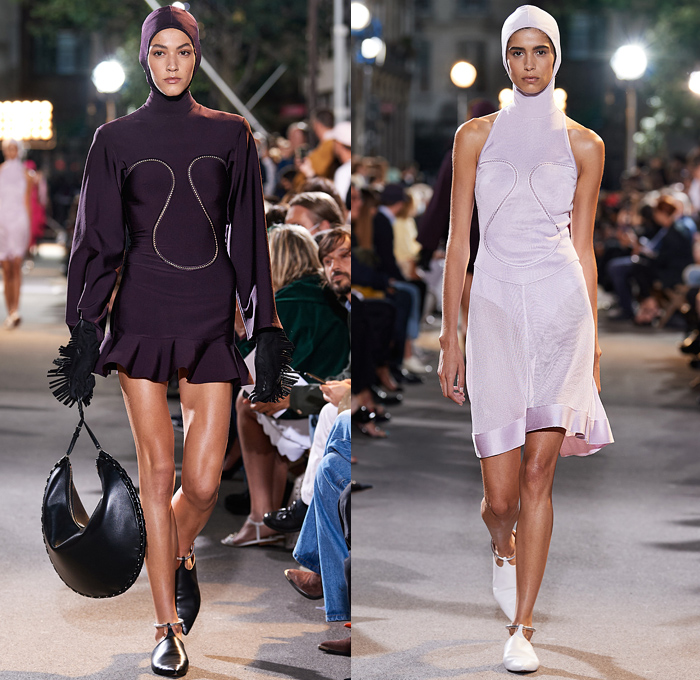 Alaïa Winter Spring 2022 Womens Runway Looks Collection - Draped Hood Denim Jeans Pantsuit Blazer Jacket Mesh Fishnet Coat Onesie Unitard Coveralls Bodysuit Jumpsuit Fringes Wide Sleeves Turtleneck Halterneck Dress Velvet Crop Top Midriff Body Contour Bodycon Fur Ribbed Knit Plastic Rainwear Parka Belt Corset Eyelets Metal Balls Bearings Bedazzled Beads Studs Poodle Skirt Shirtdress Miniskirt Sheer Tulle Gown Fringes Leggings Tights Gloves Handbag Tote Clogs