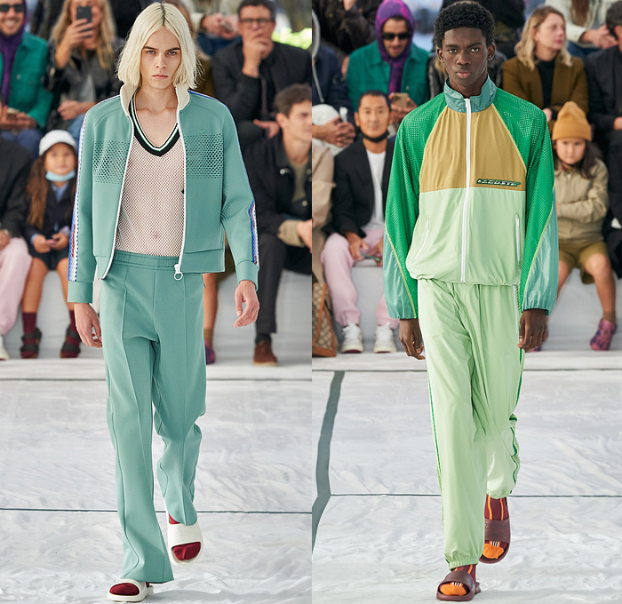 Lacoste 2022 Spring Summer Mens Runway Looks Collection - Mode à Paris Fashion Week France - Sporty Casual Athleisure Sleeveless Tank Top Straps Belts Cords Tied Knot Mesh Neoprene Tennis Shirt Knit Sweater Threads Logo Frayed Raw Hem Stripes Logo Patchwork Anorak Coat Parka Hoodie Trackwear Track Jacket Shorts Socks Slippers Sliders Trainers Sneakers