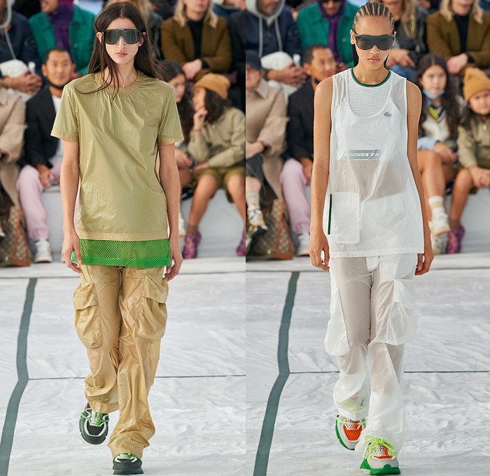 Lacoste 2022 Spring Summer Womens Runway Looks Collection - Mode à Paris Fashion Week France - Sporty Casual Athleisure Sunglasses Visor Hat Rainwear Coat Parka Anorak Knit Oversized Sweater Translucent Pockets Straps Belts Cords Tied Carabiner Mesh Track Jacket Shorts Culottes Cargo Pants Vest Logo Crop Top Midriff Neoprene Tennis Shirt Threads Frayed Raw Hem Patchwork Miniskirt Skirt Hotpants Socks Sneakers Sandals Handbag Bag Tote