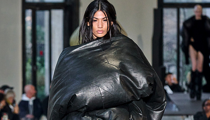 Rick Owens 2023-2024 Fall Autumn Winter Womens Runway Collection - Paris Fashion Week Femme PFW - Luxor - Selvedge Denim Jeans Shredded Acid Colored Degrade Bedazzled Sequins Quilted Puffer Pillow Jumbo Padded Duvet-Filled Wrapped Slung Cowl Donut Puff Ball Knit Oversized Outerwear Coat Draped Crumpled Arm Floaties Funnelneck Sweater Dress Patchwork One Shoulder Pleats Cape Cloak Metallic Frankenstein Shoulders Fringes Bat Wing Collar High Slit Skirt Briefs Wrapped Platform Boots