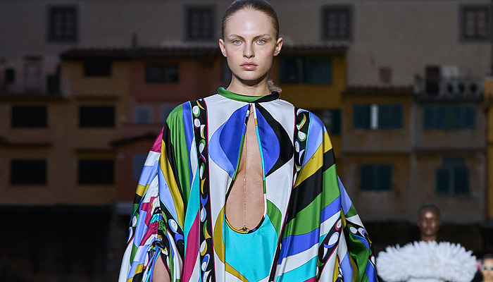 Emilio Pucci 2023 Spring Summer Womens Runway Collection - Initials EP - Denim Jeans Leaf Top Swirls Geometric Tribal Stripes Iride Marmo Girandole Print Miniskirt Bandeau Strapless Blouse Onesie Jumpsuit Unitard Hood Balaclava Chain Harness Blazer Jacket Adorned Paillettes Noodle Strap Wide Leg Neoprene Swimwear Bikini Leggings Tights Halterneck Fringes Dress Caftan Hanging Sleeve Foil Puff Ball Shorts Parka Raincoat Inflatables Cords Basket Vase Handbag Sack Bucket Hat Flats Boots