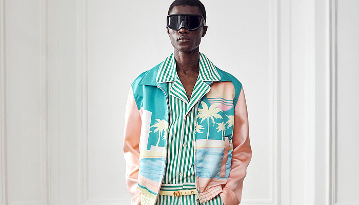 Balmain 2024 Pre-Fall Autumn Mens Lookbook - Miami Vice Florida Palm Trees Silhouette 1980s Eighties Tropical Tweed Motorcycle Jacket Hoodie Sweatshirt Sleeveless Moto Biker Pants Skinny Flare Knee Panels Bedazzled Studs Sequins Crystals Beads Velvet Quilted Patchwork Stripes Blazer Harlequin Check Pointed Lapel Pockets Padded Boxy Shoulders Tuxedo Long Coat Outerwear Denim Jeans Colorblock Boots Sunglasses Shades Handbag