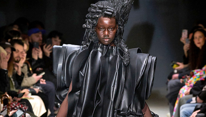 Comme des Garçons 2024-2025 Fall Autumn Winter Womens Runway Looks - Paris Fashion Week Femme PFW - Anger - Vinyl Pleather Capelet Pellegrina Zipper Ruffles Layers Pleats Panels Sculpture Tied Knot Wrap Flare Deconstructed Asymmetrical Crinoline Lantern Skirt Flowers Floral Roses Poodle Skirt Outerwear Jacket Barbed Wires Chains Frankenstein Padded Shoulders Fringes Pinafore Dress Pockets Straps Balloon Bloated Puff Sleeves Poufy Shoulders Judge Wigs