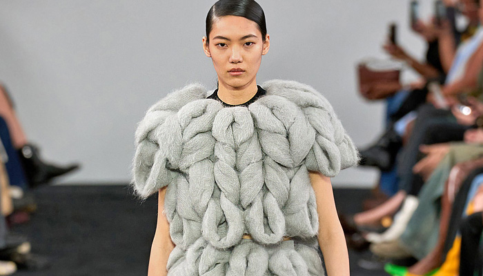 JW Anderson 2024-2025 Fall Autumn Winter Womens Runway Collection - London Fashion Week LFW UK - Chunky Sculpture Knit Grandma Braid Sweater Jumper Ribbed Shorts Layers Tiered Flaps Leather Wool Cinch Bulb Dress Sweaterdress Crop Top Midriff Miniskirt Tied Wrap Suede Stripes Vest Tabard Chevron Draped Twist Knots Sheer Tassels Curtain Trompe L'oeil Flowers Floral Rosettes Streamers Fringes Shirtdress Oversized Coat Motorcycle Biker Jacket Fur Loafers Handbag
