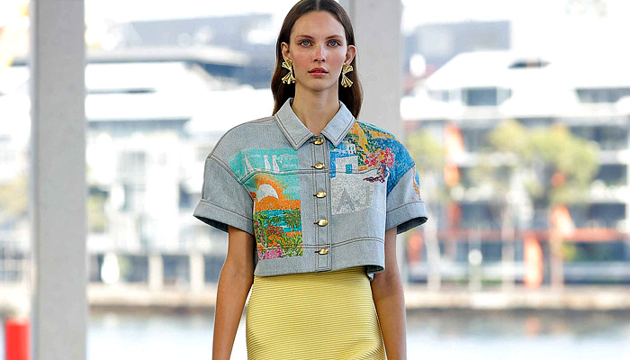 Aje 2026 Resort Cruise Pre-Spring Womens Runway Collection - Australian Fashion Week - Impression - Denim Jeans Biker Jacket Shorts Miniskirt Embroidery Flowers Floral Dress Puff Ball Poufy Wide Leg Petals Tabard Landscape Illustration Crop Top Midriff Fringes Column Skirt Mini Dress Long Sleeve Shirt Strapless One Shoulder Tiered Frills Draped Gown Eveningwear Halterneck 