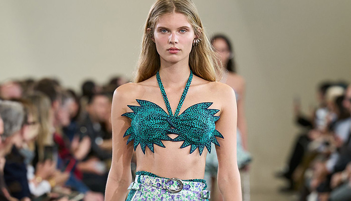 Paco Rabanne 2026 SS PFW: sequin cutout blouses, halterneck bikini tops, metallic foliage, floral miniskirts, capri leggings, oversized belts, crystal gems, bug-eye sunglasses, Paris runway.