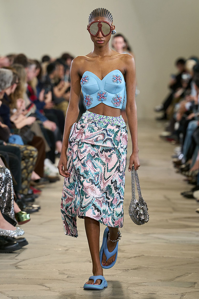 Paco Rabanne 2026 SS PFW: sequin cutout blouses, halterneck bikini tops, metallic foliage, floral miniskirts, capri leggings, oversized belts, crystal gems, bug-eye sunglasses, Paris runway.