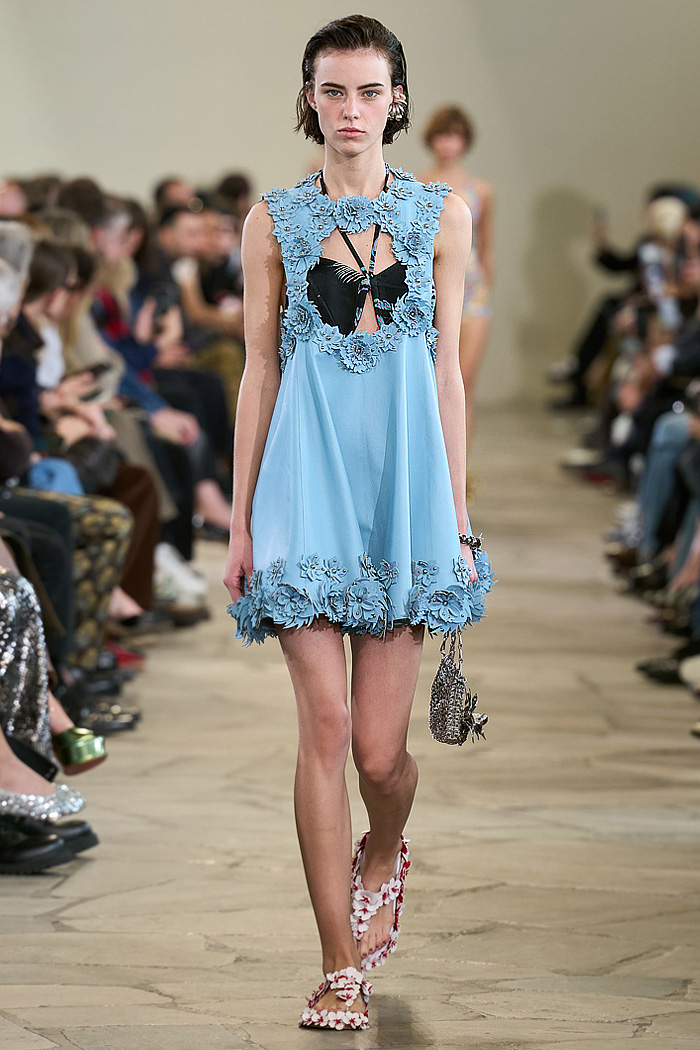 Paco Rabanne 2026 SS PFW: sequin cutout blouses, halterneck bikini tops, metallic foliage, floral miniskirts, capri leggings, oversized belts, crystal gems, bug-eye sunglasses, Paris runway.