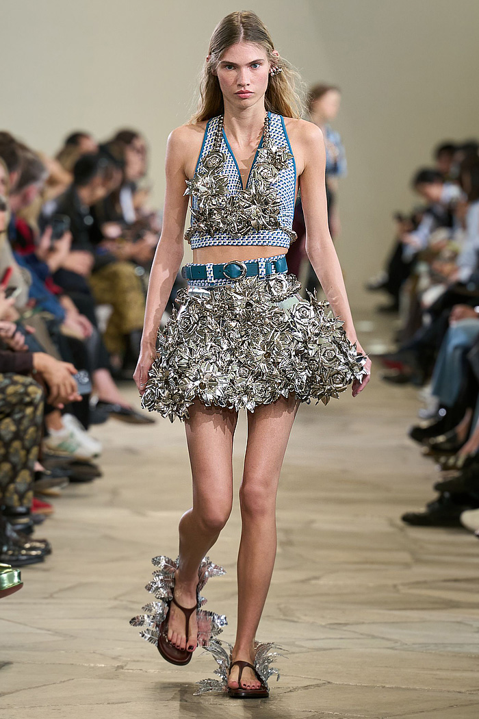 Paco Rabanne 2026 SS PFW: sequin cutout blouses, halterneck bikini tops, metallic foliage, floral miniskirts, capri leggings, oversized belts, crystal gems, bug-eye sunglasses, Paris runway.
