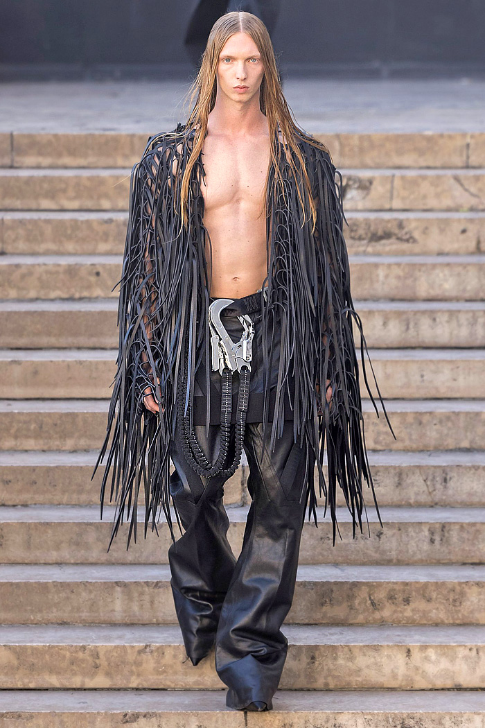 Rick Owens 2026 Spring Summer Mens: vest, sequins, tabard, studs, straps, crop jacket, biker, fringes, carabiner, wrapped boots